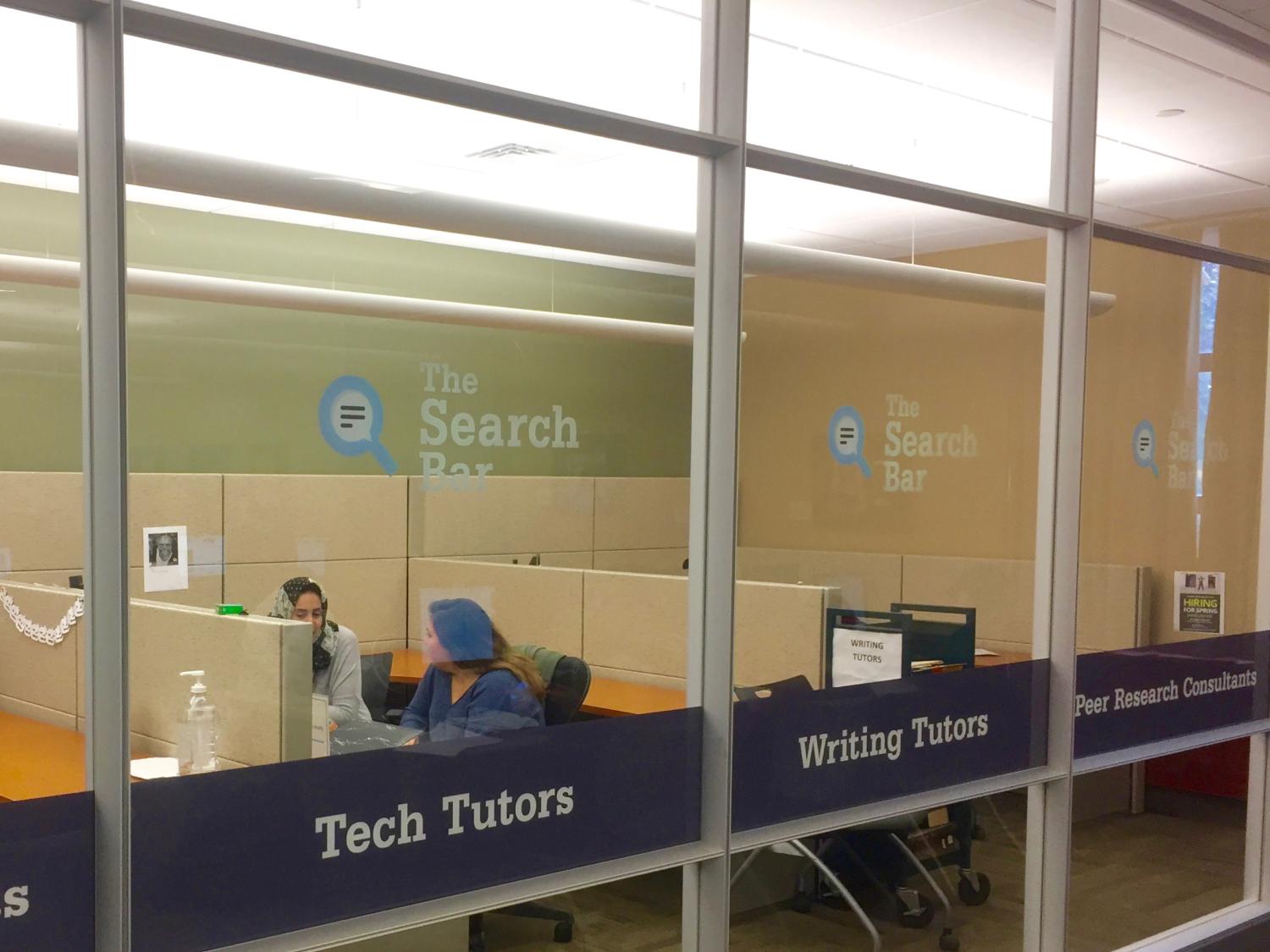 two students sitting and talking in peer consultation space 