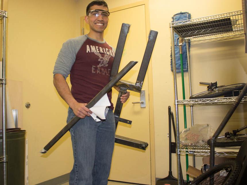 James Smith works with the pieces that will soon create Penn State's Human Powered Vehicle.
