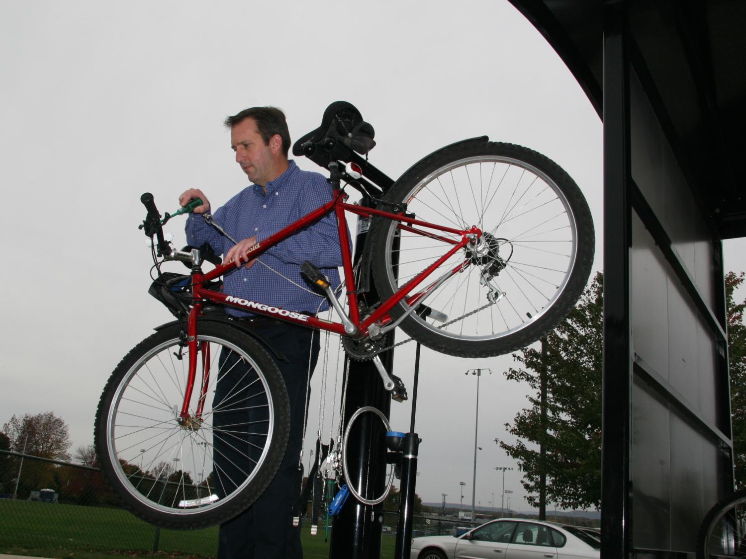 Tom Flynn, OPP Landscape Architect demonstrates the new bicycle repair station