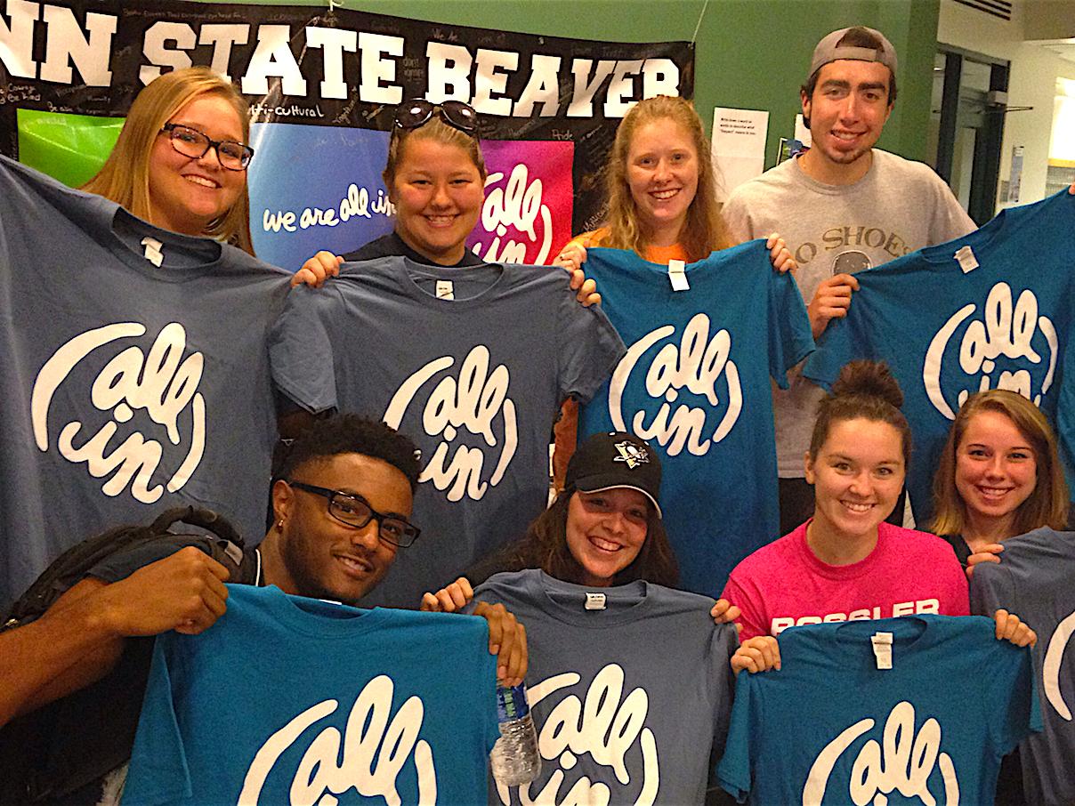 Eight Beaver students pose with their "All In" T-shirts in the Brodhead Bistro.