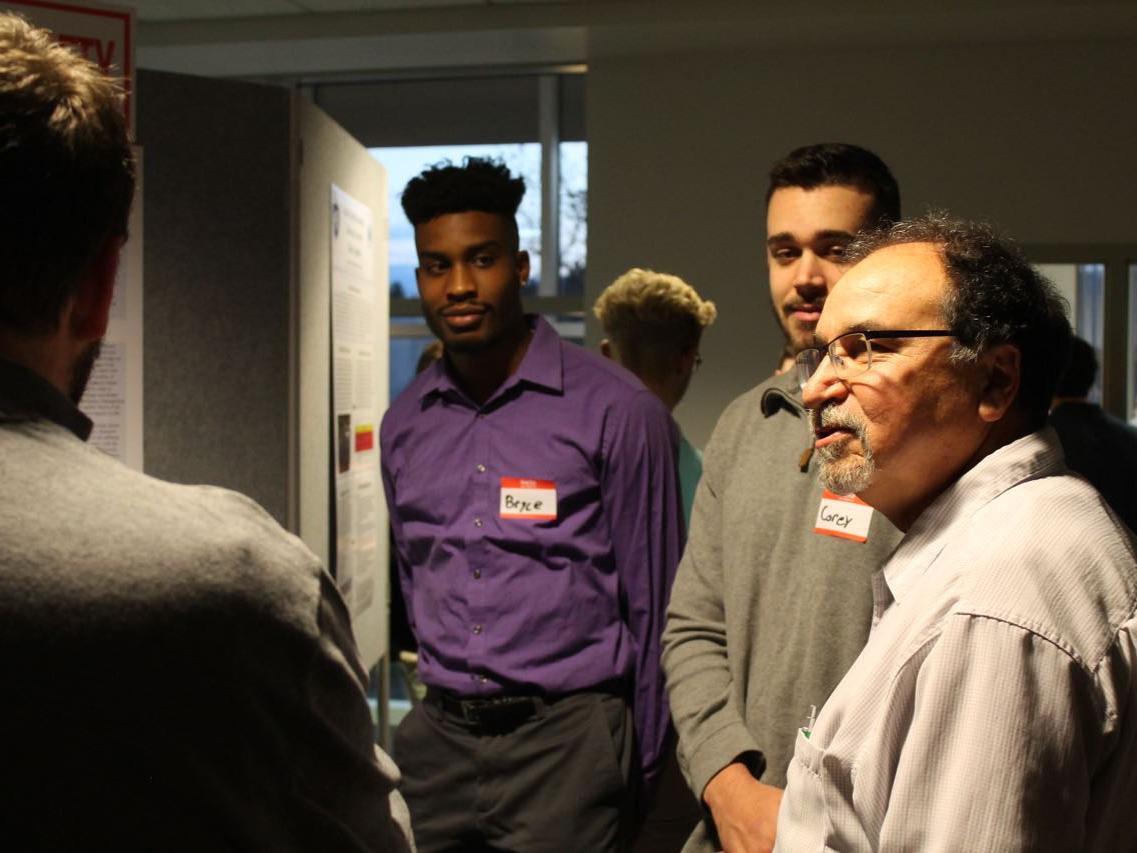 Alan Sam, environmental coordinator for State College Borough, speaks with students about their Sustainable Communities Collaborative project at the Fall 2018 Sustainability Expo