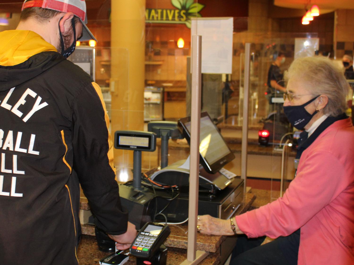 Port Sky cashier Theresa "Terry" Karcz helps a Penn State Altoona student "swipe out hunger" 