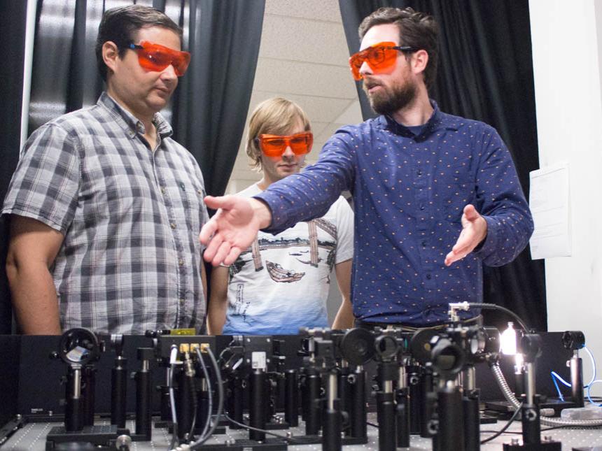 Carlos Perez (left) and Devon Eichfeld (center) collaborating with Brian Foley (right).