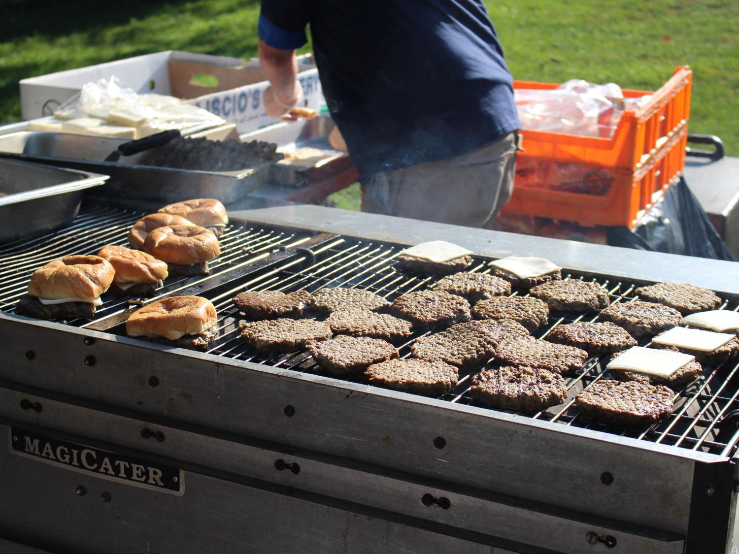 Photo of a grill with burgers.