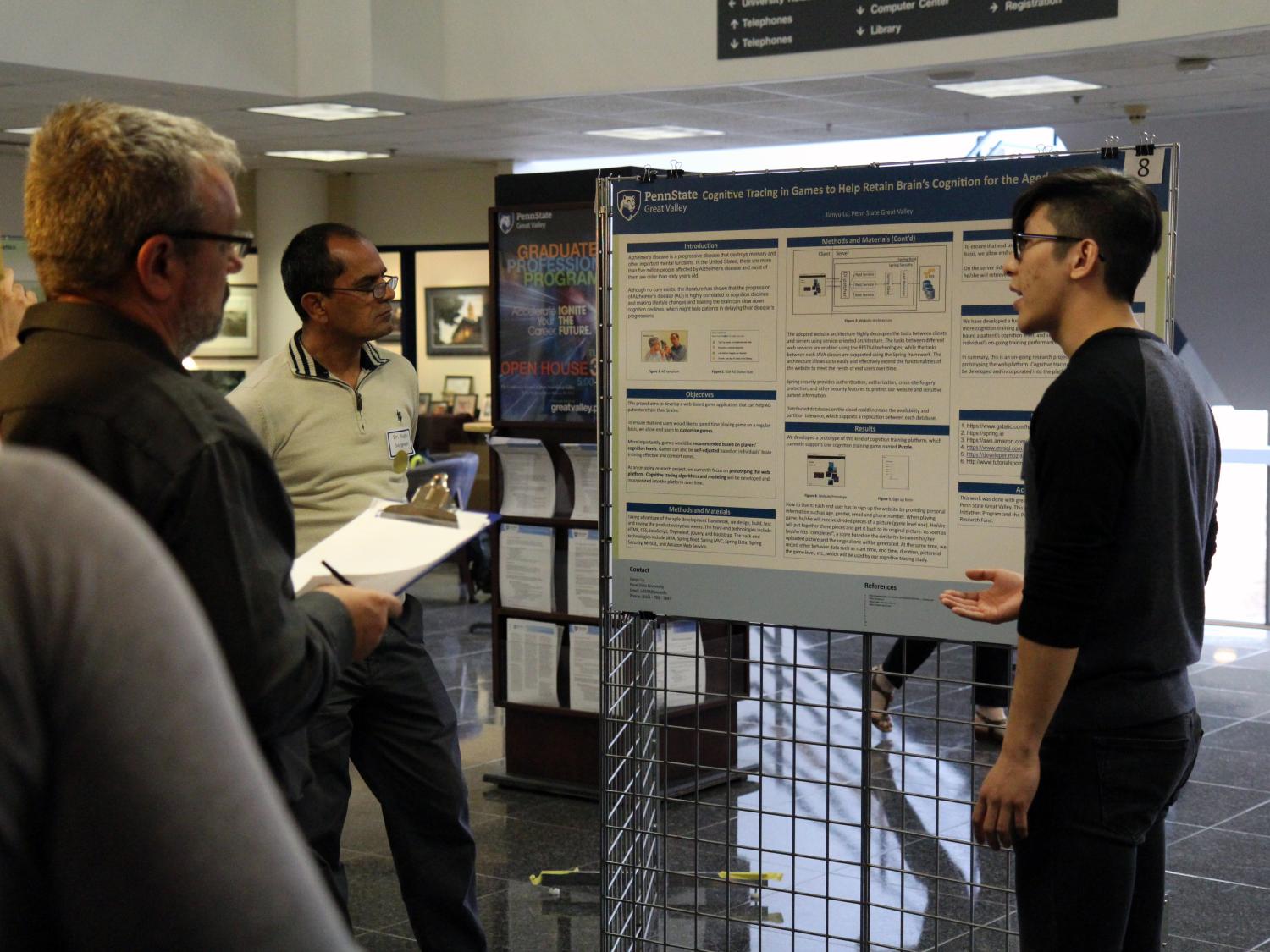 Engineering student presenting research to judges