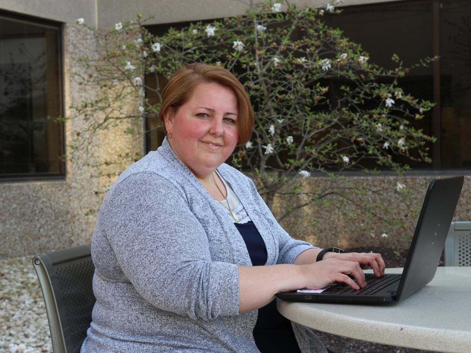 Jackie Markle seated with a laptop