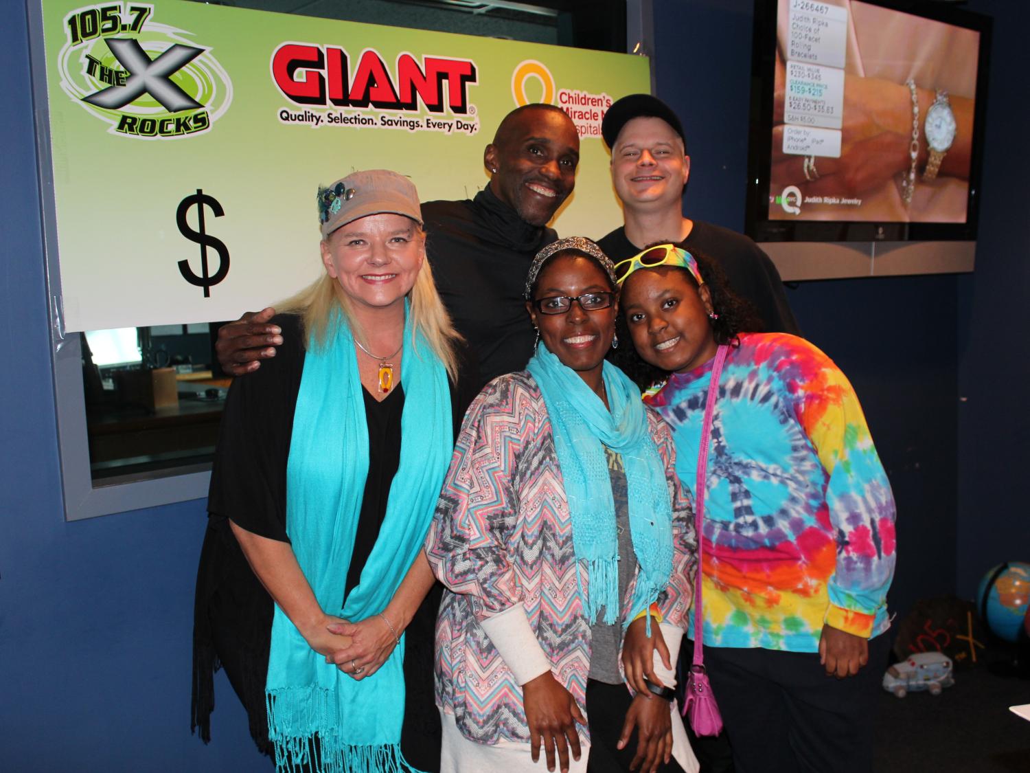 WQXA-FM 105.7 The X on-air hosts pose with a patient and her mother