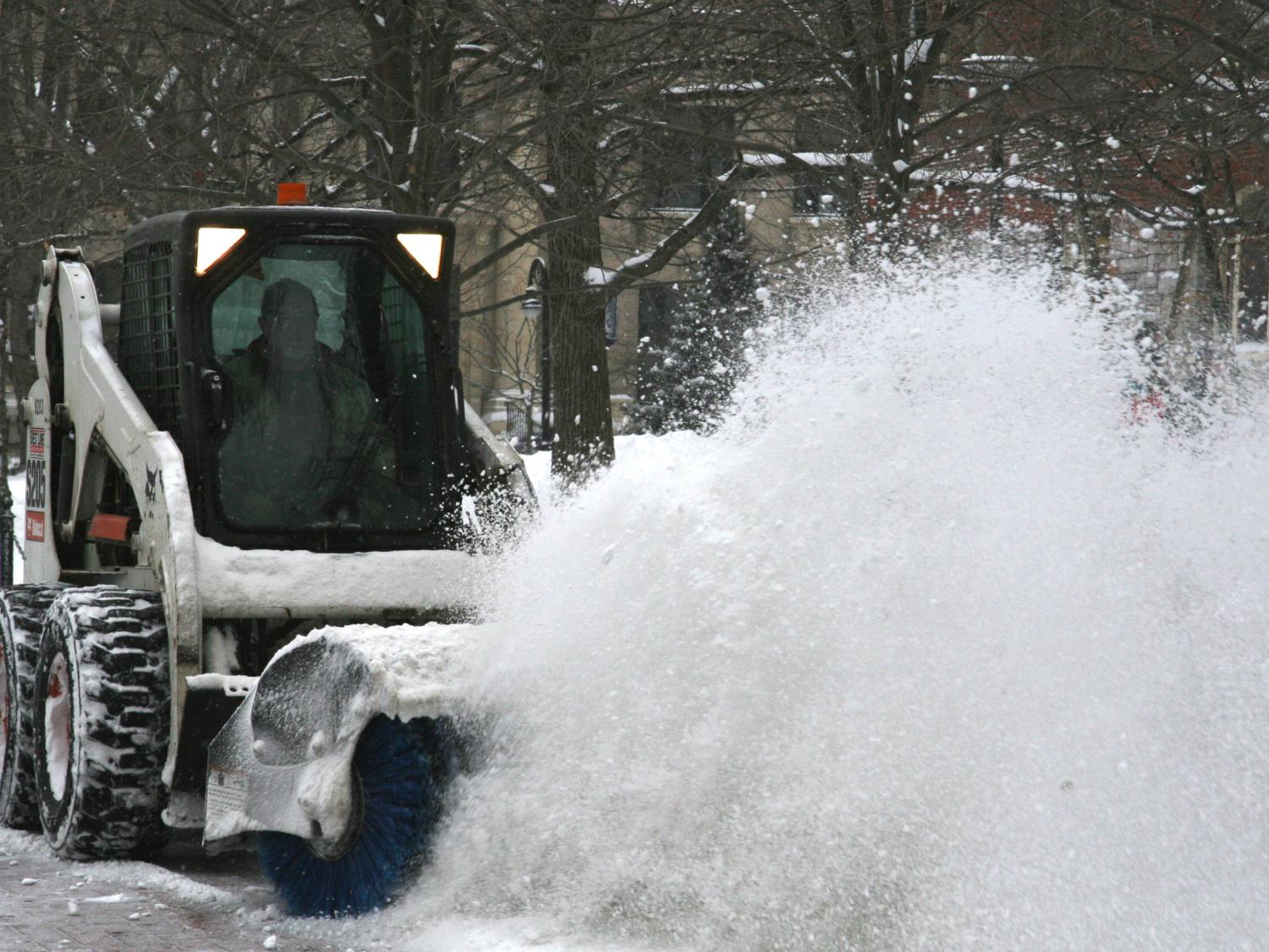 OPP staff work to clear sidewalks during Monday's snow event.