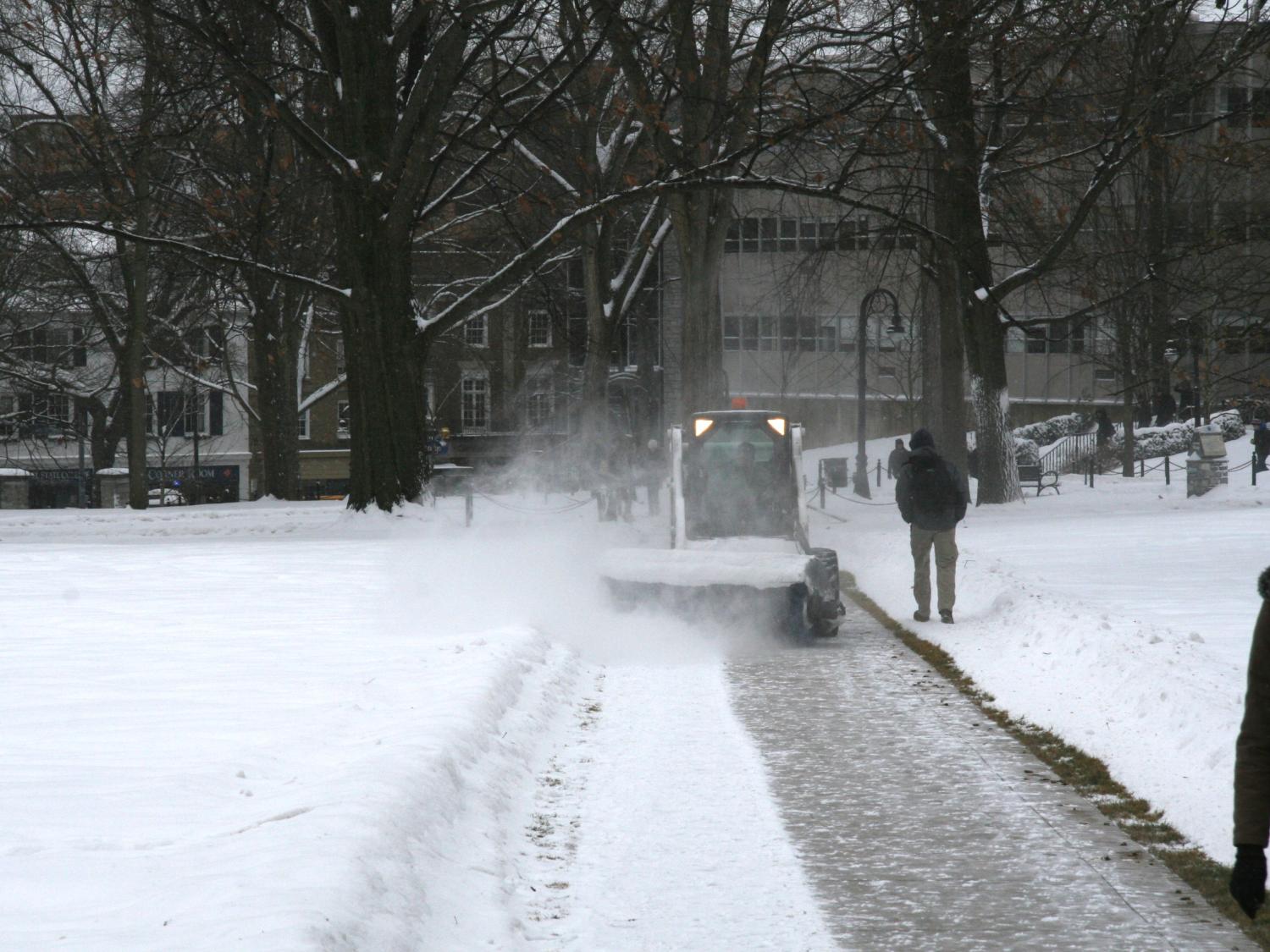 OPP staff clear sidewalks near Old Main.