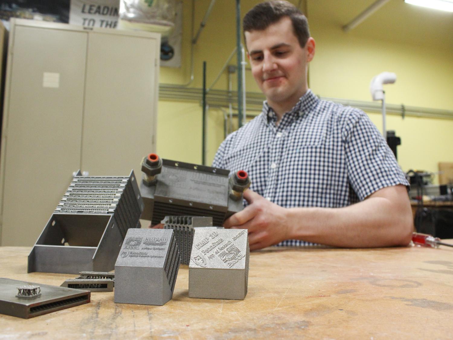 Michael Bichnevicius works with additive manufactured parts in the ExCCL Lab.