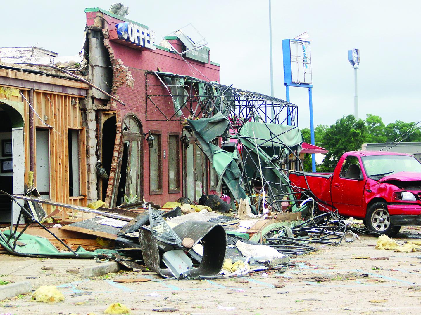 brick storefront that suffered major damage after a tornado