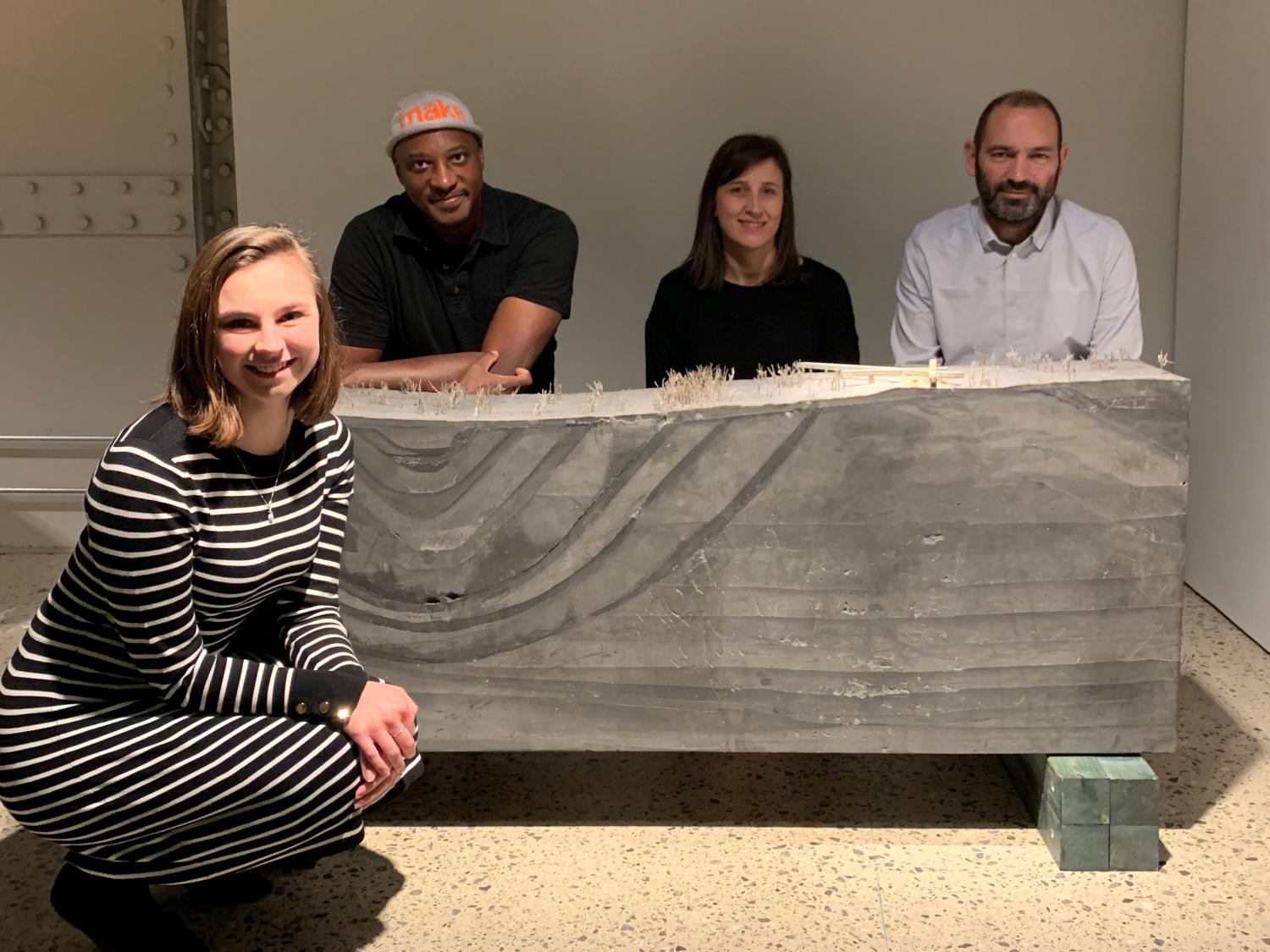 The Penn State team of Miranda Esposito, Marc Miller, Laia Celma, and Pep Aviles pose in front of their model