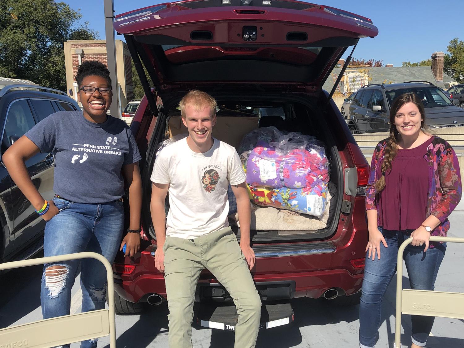 Fresh START committee members load up a vehicle with Fleece & Thank You blankets for the Penn State Children's Hospital 