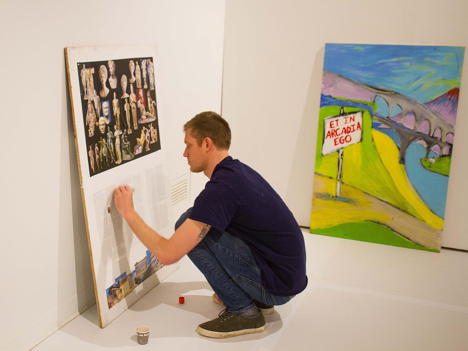 Aaron Ziolkowski installs work for "Canon Fodder."  