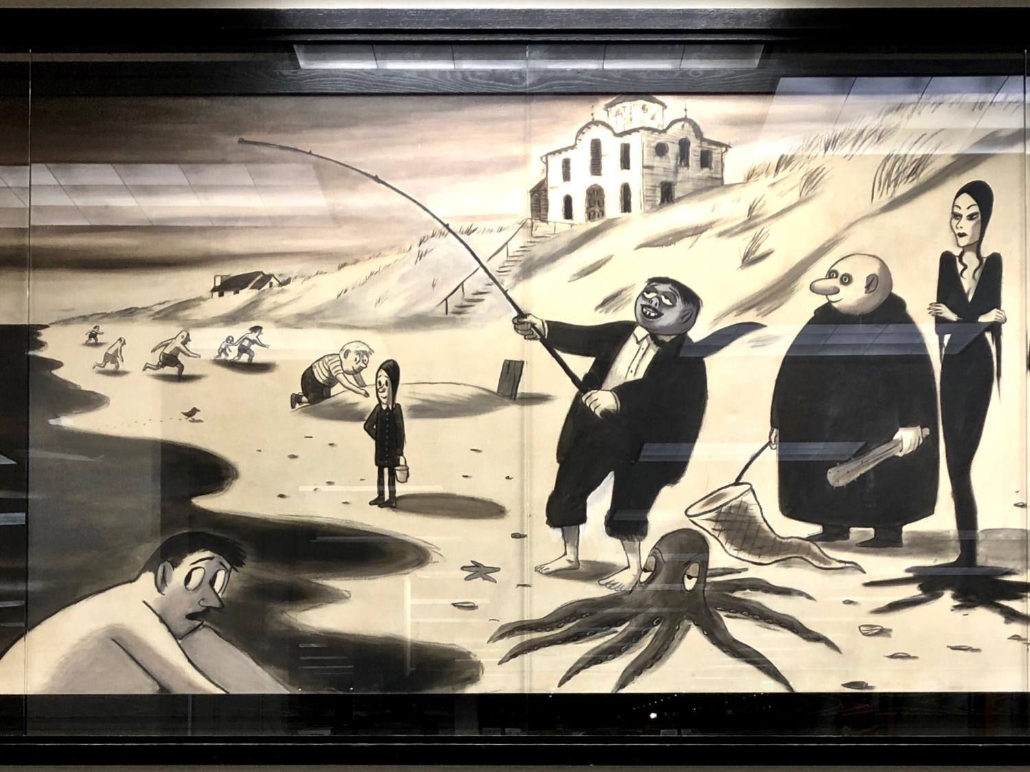 strong horizontal image of black and white mural depicting famous American ghoulish cartoon Addams family standing, fishing on beach shoreline and scared swimmers racing to get out of water