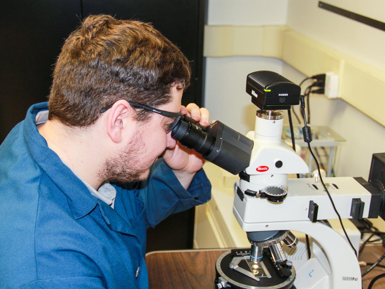 Nathan Gendrue, graduate student in mining and mineral process engineering who is advised by Shimin Liu, reviews the characterization of coal dust under a high-resolution microscope.