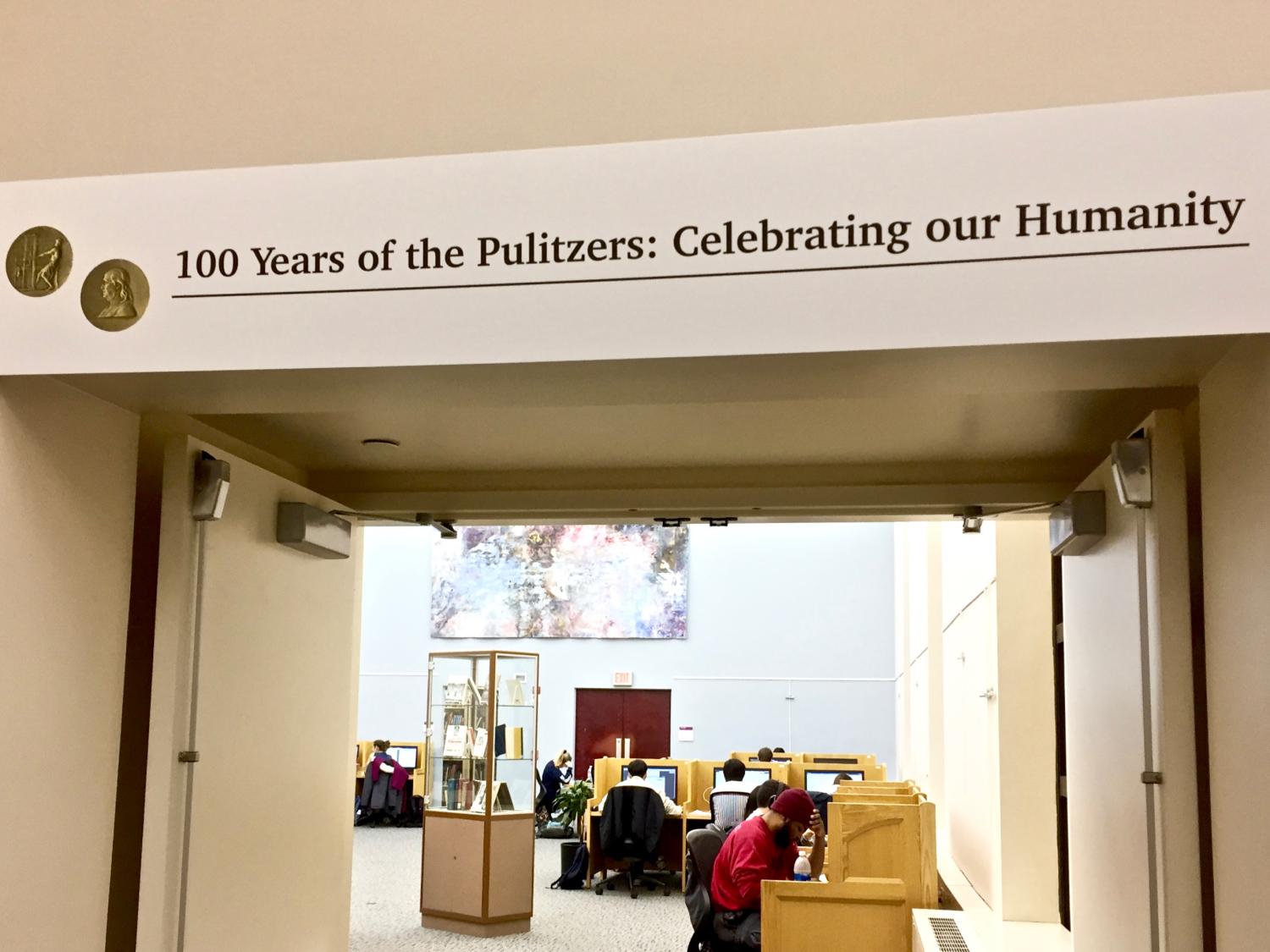 photo of exhibit title banner across top of doorway to study room holding exhibit cases