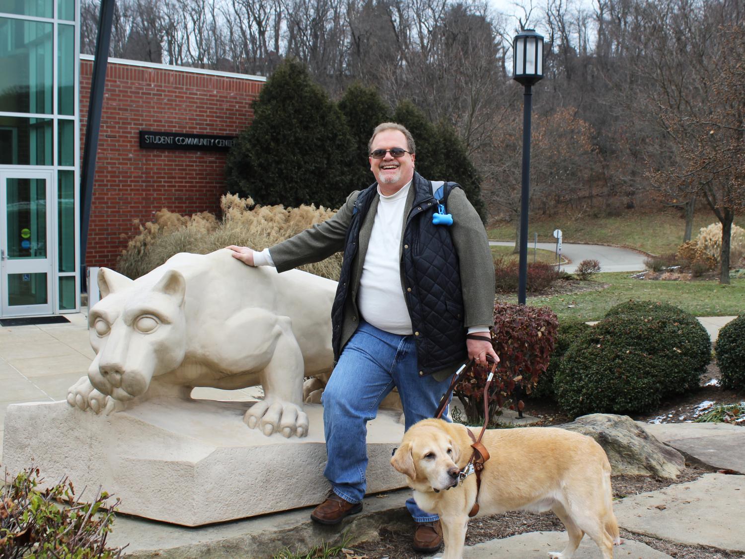 Jerry Pastories and Service Dog Nittany standing in front of the lion shrine