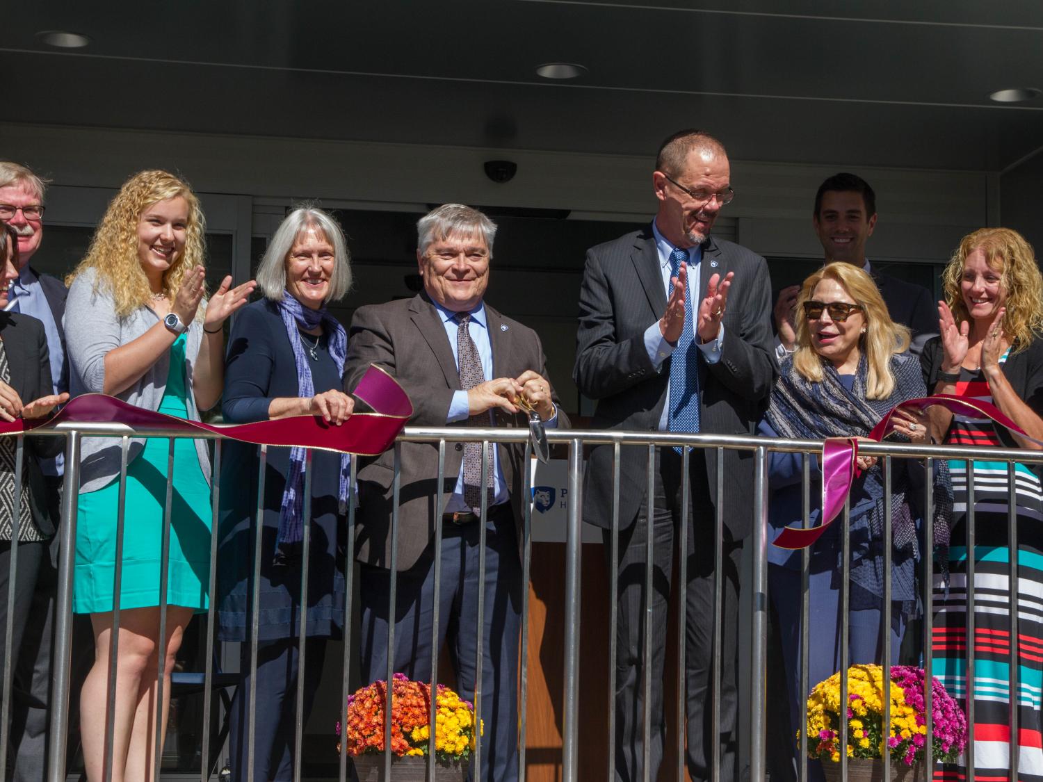 The group celebrates the rededication of the Kostos Building.