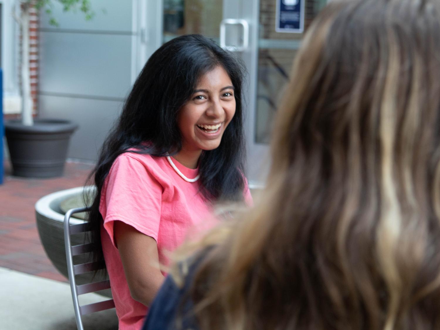 Female student laughing with a friend
