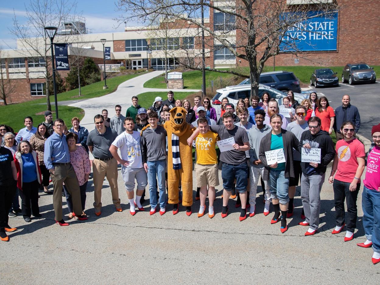 Group of men and women stand for group photo