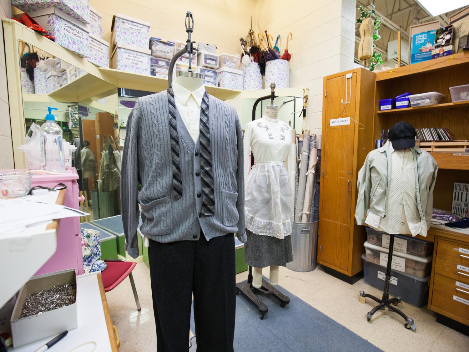 The jazz trio costumes from "Trouble in Tahiti" rest on forms in the costume shop. 