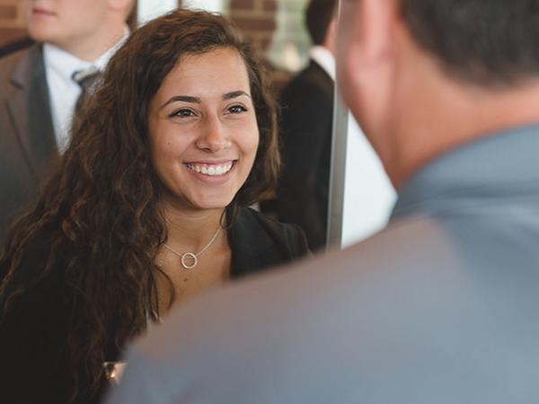 Woman at career fair talks with potential employer 