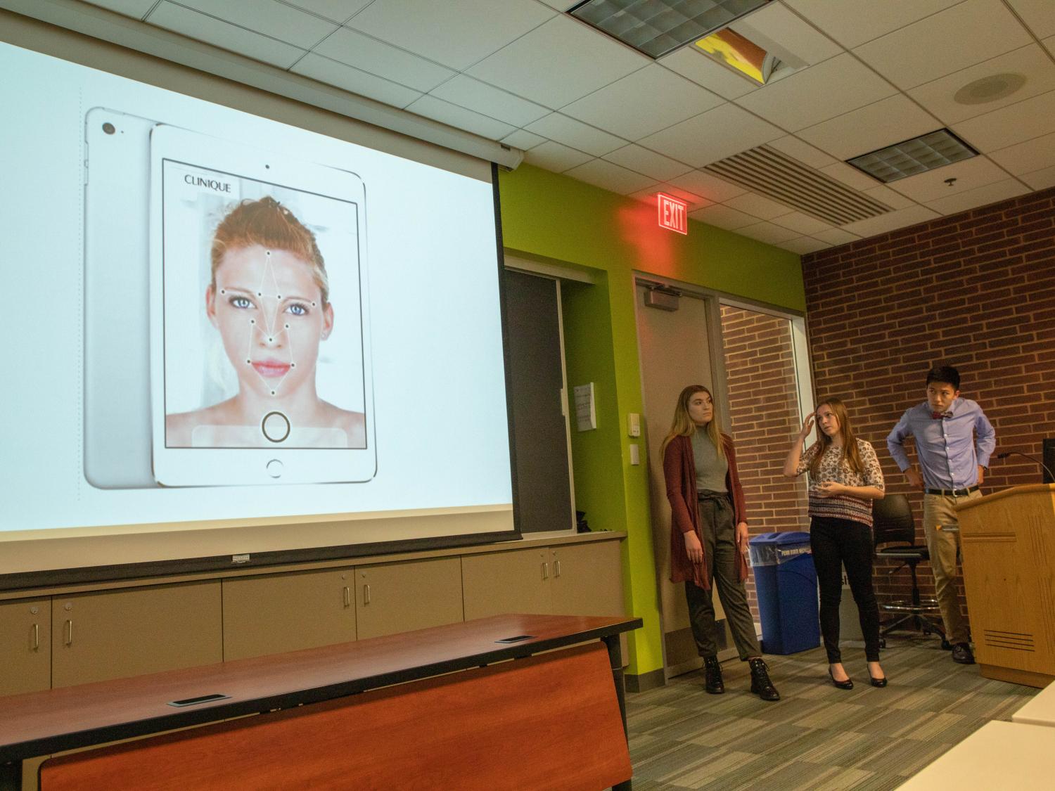 3 students presenting Clinique project in HCDD 113
