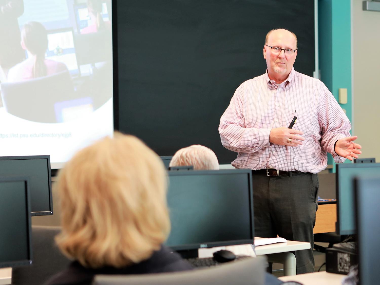 Ed Glantz teaches at the front of a class