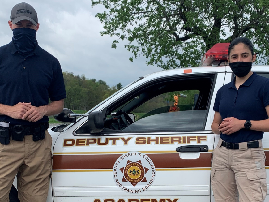 Man and woman standing in front of a car