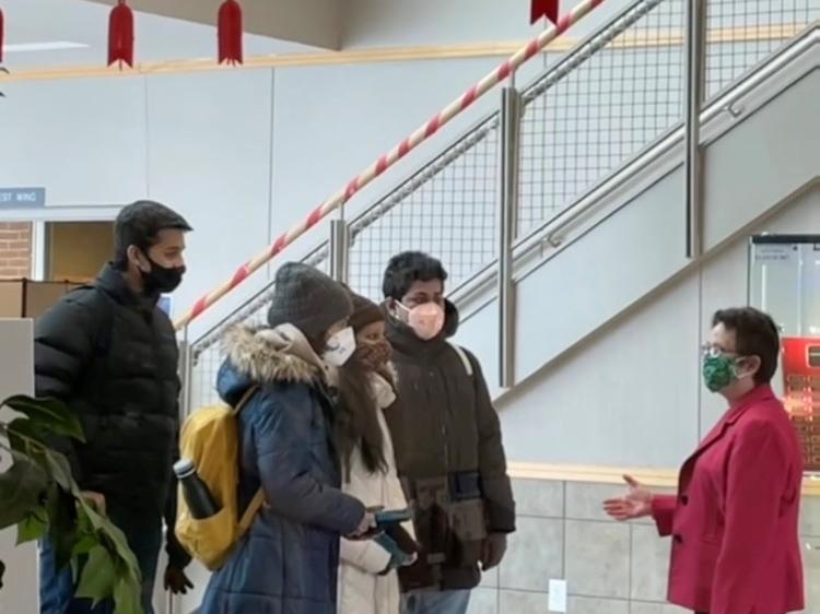 Four students being welcomed to campus