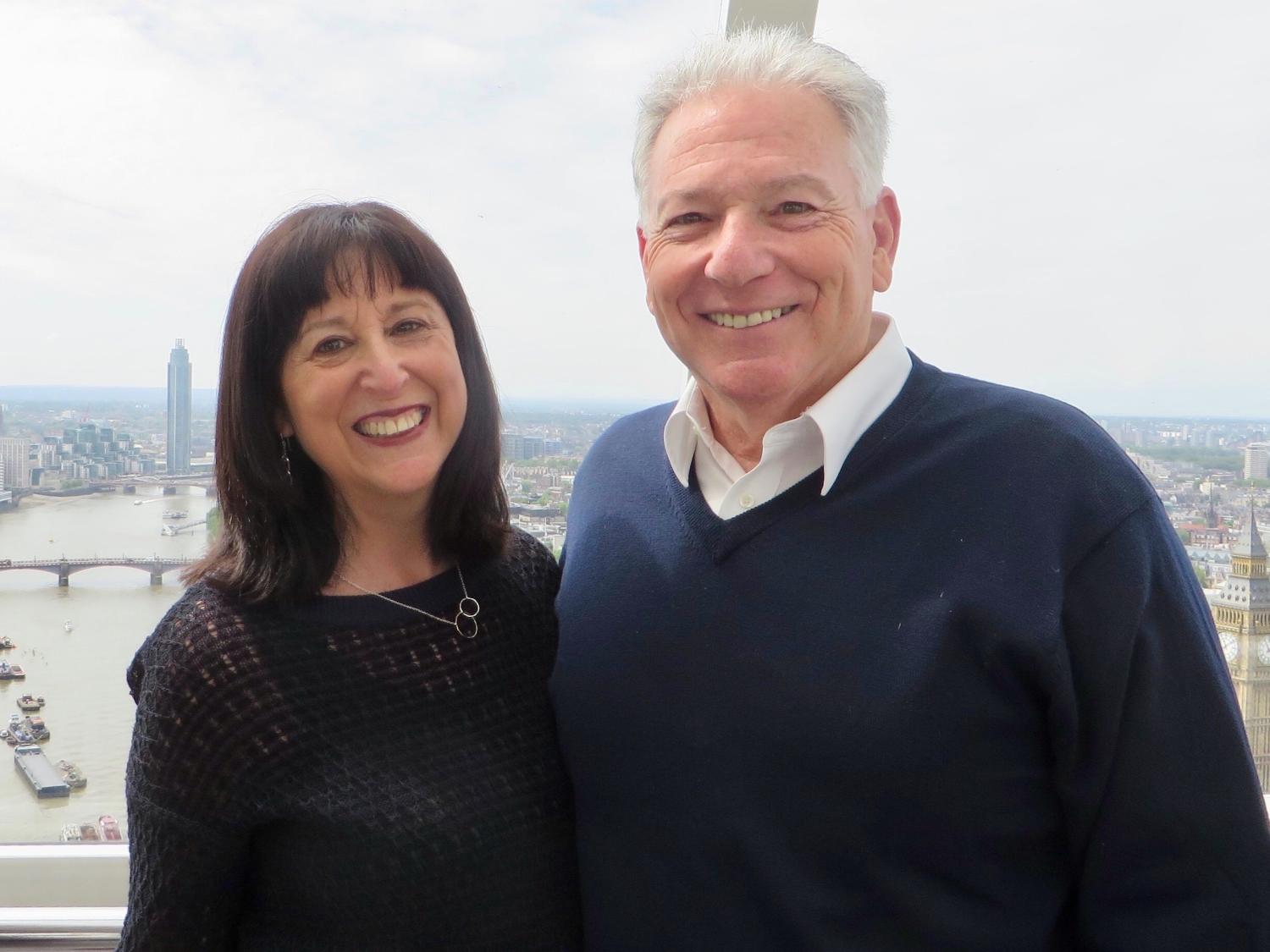 Iris and Ed Beckwith pose in front of an urban overlook