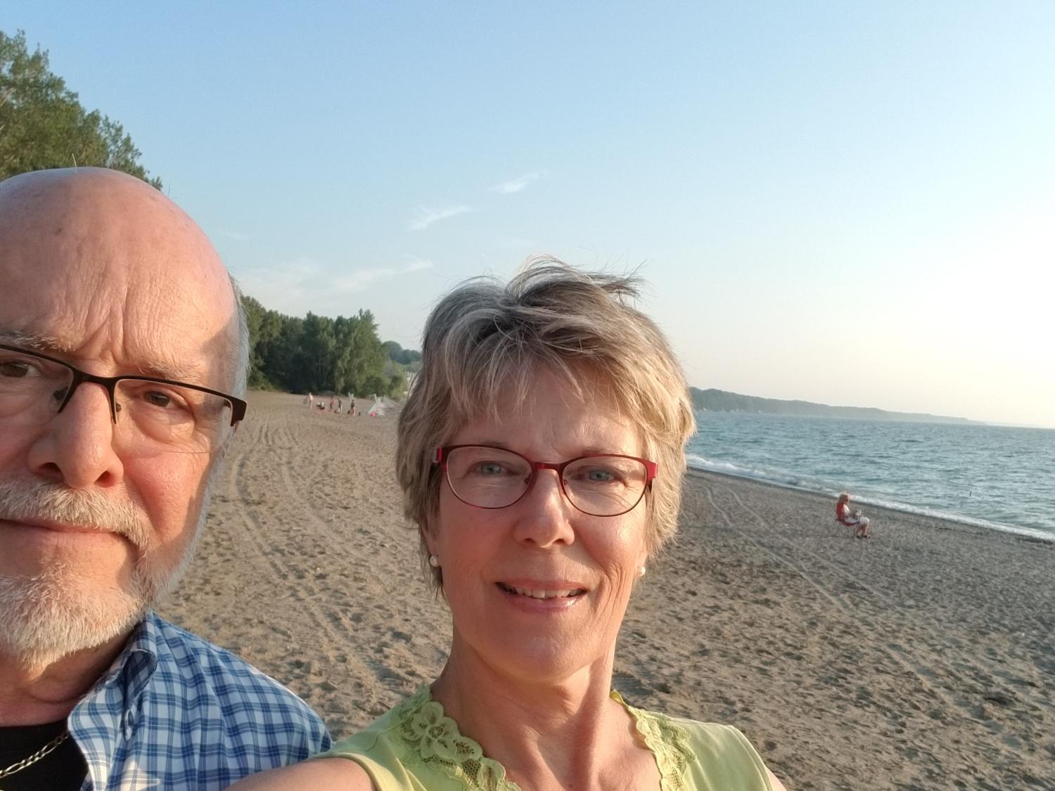 A selfie of James and Sandra Schlaudecker on a beach