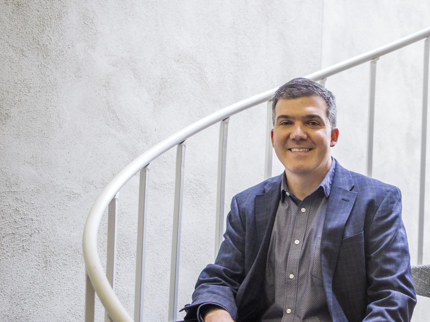 Jason Rekulak sits on his publishing house's spiral staircase