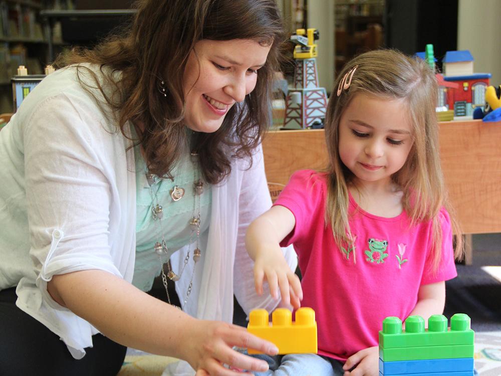 Jenn Zosh playing with child 