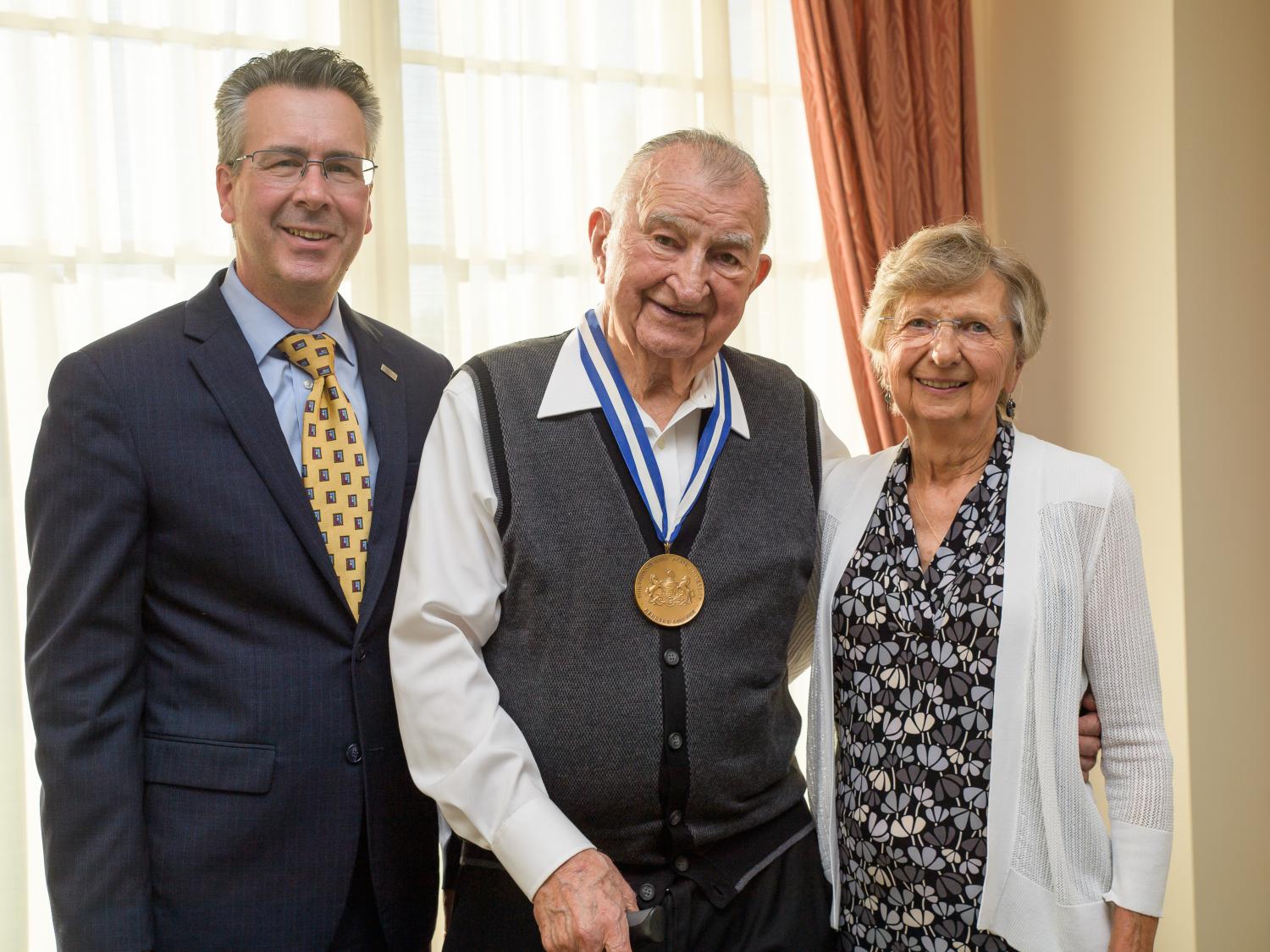 Penn State Behrend Chancellor Ralph Ford presents the Behrend Medallion to Joe and Isabel Prischak