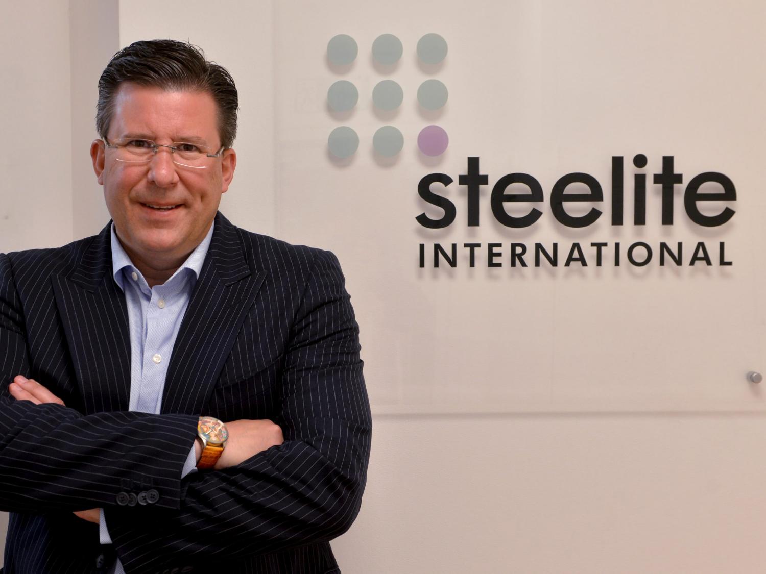 John Miles in front of Steelite sign