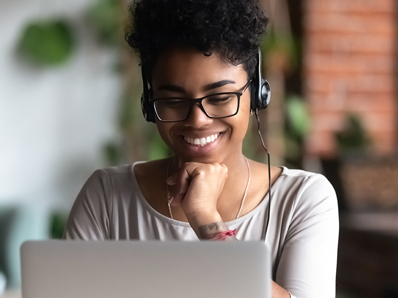 Woman smiling while looking at computer