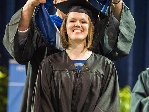 MBA in Pittsburgh graduate receiving her hood