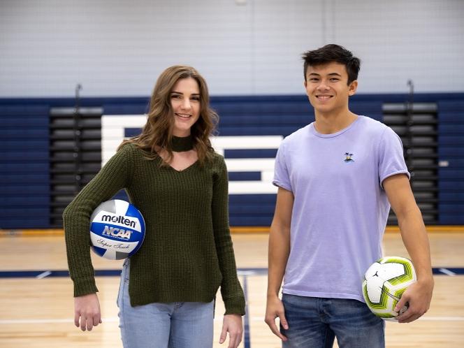 Woman and man stand in gymnasium