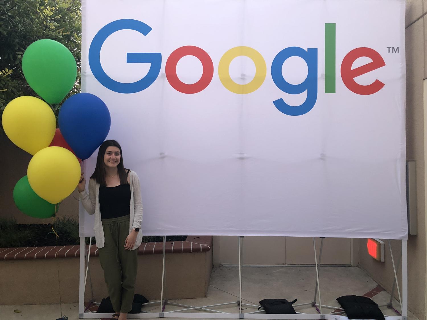 Kelsie McElroy in front of a Google backdrop with balloons