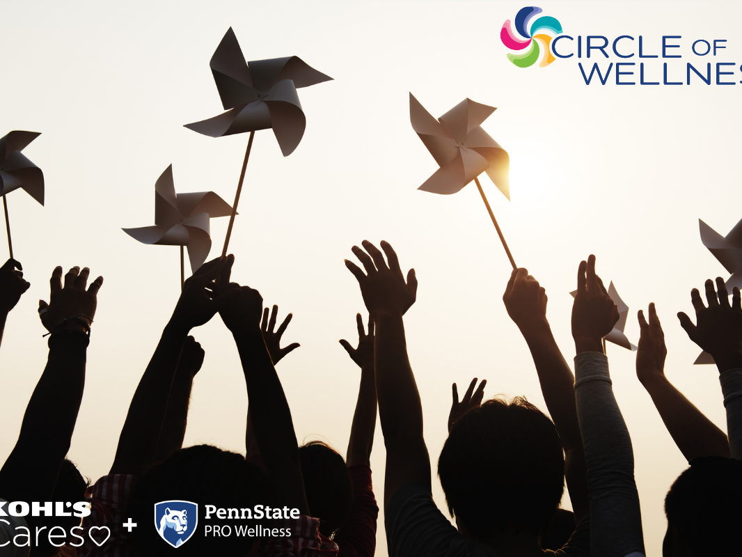 The silhouettes of a few children with arms outstretched, holding pinwheels in the air.