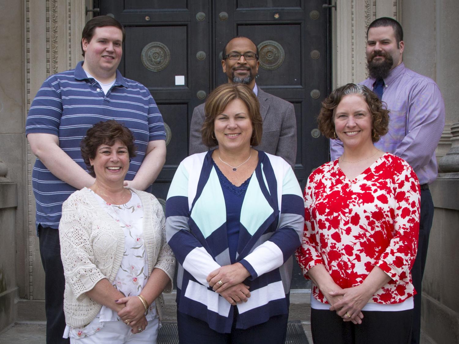 Group Photo of: Alex Towle, Paul Taylor, Stephen Moczydlowski, Staci Kelly, Kim Smith and Jennifer Hessert. In front of Sparks Building
