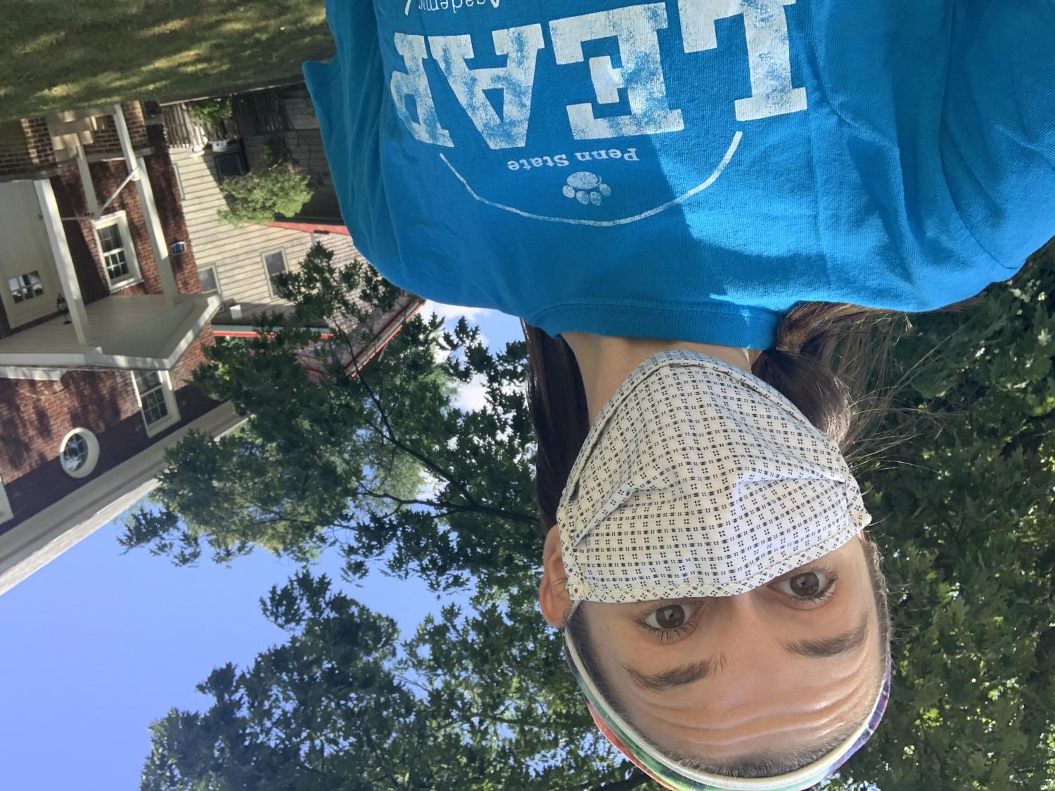 A masked LEAP mentor poses for a selfie.