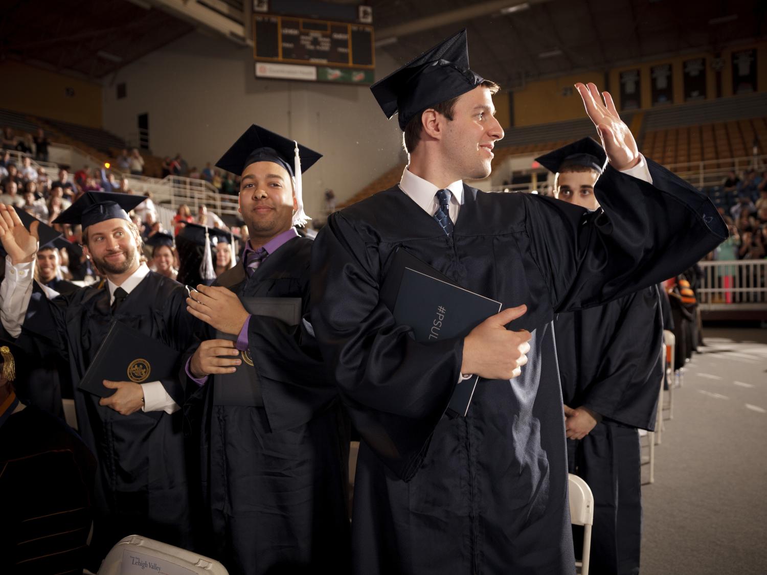 Graduates acknowledge the crowd's applause during PSU LV commencment.