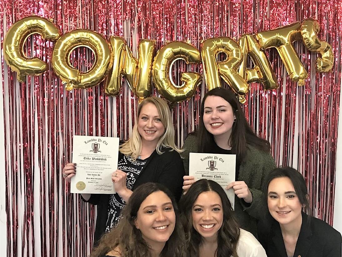 New and recently inducted members of Lambda Pi Eta pose for a group photo