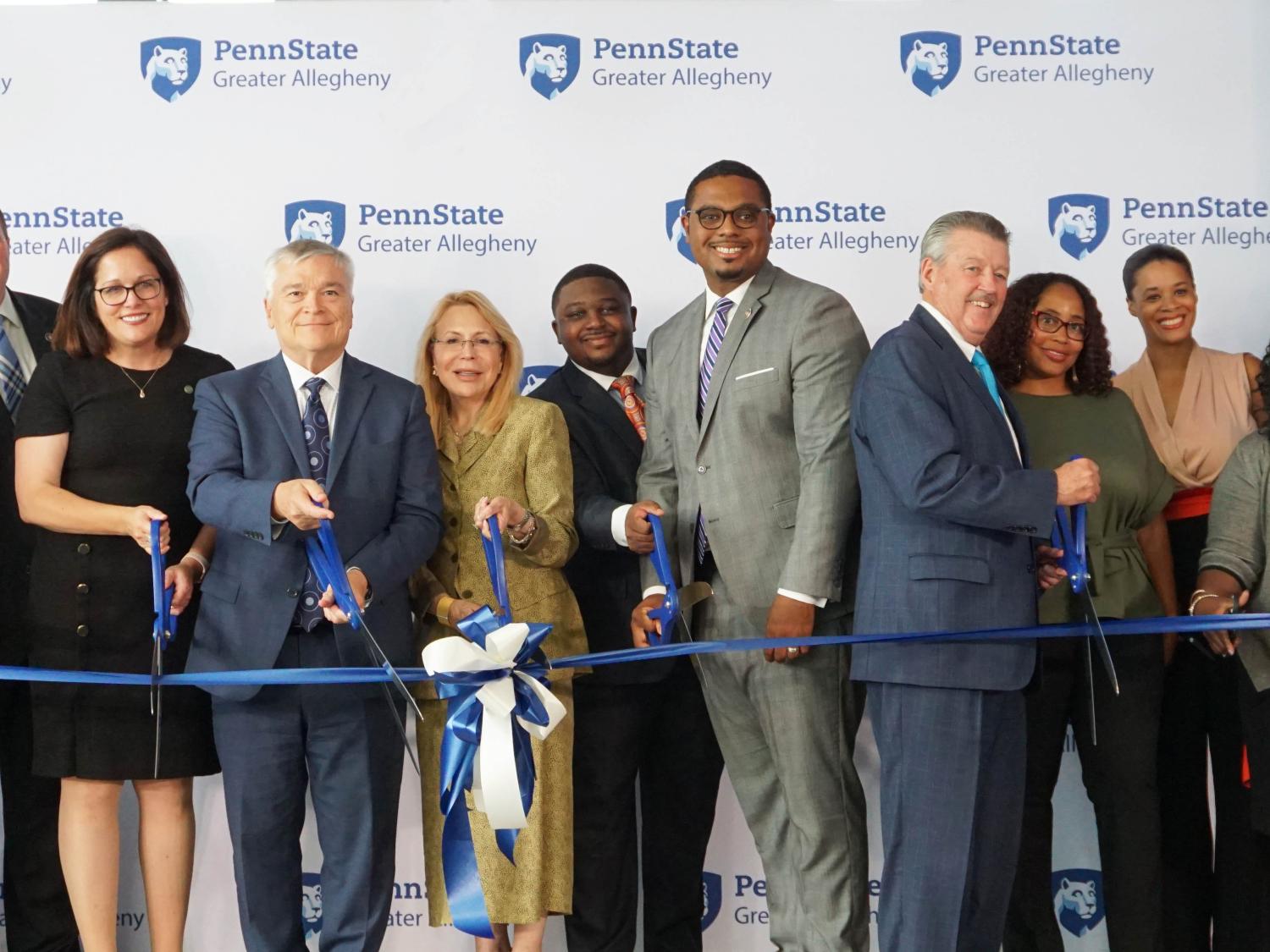 people cutting a ribbon