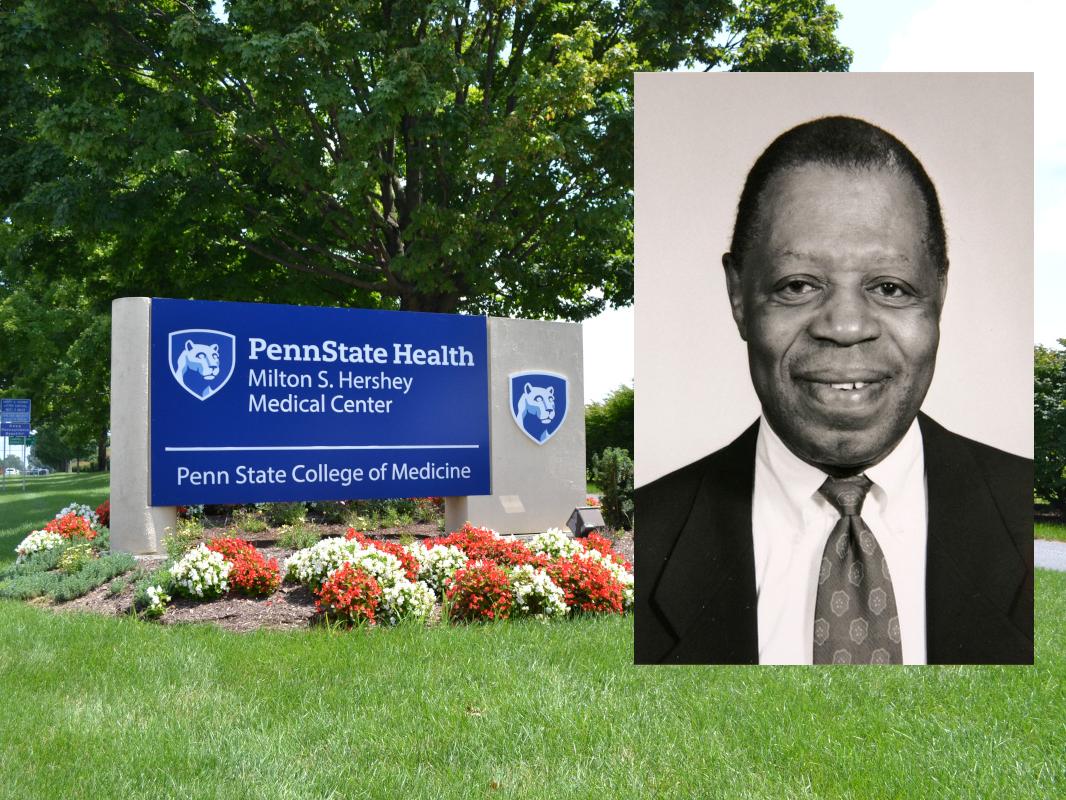 A man dressed in a suit and tie smiles for a photo