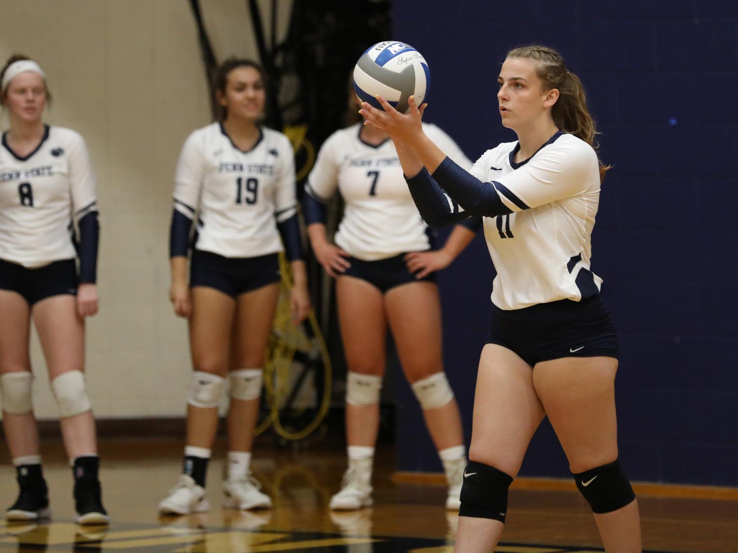 Penn State Brandywine first-year student Lexie Berry prepares to serve during a volleyball match.