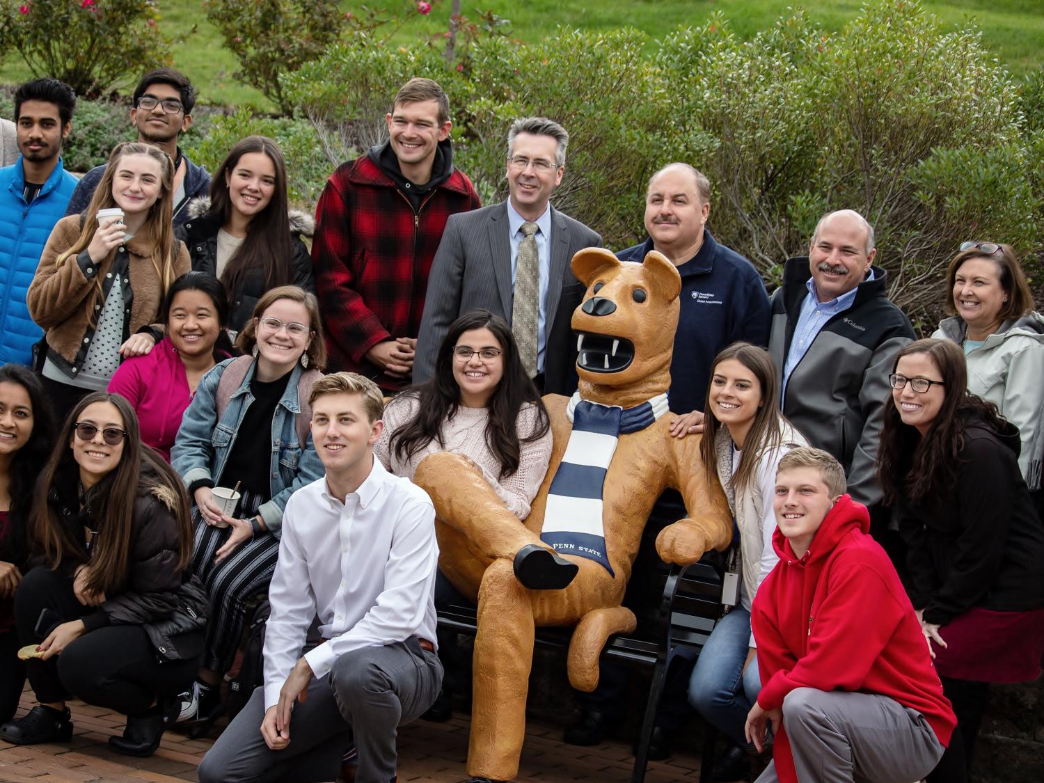 Students, faculty and staff pose at Penn State Behrend's new Nittany Lion bench.